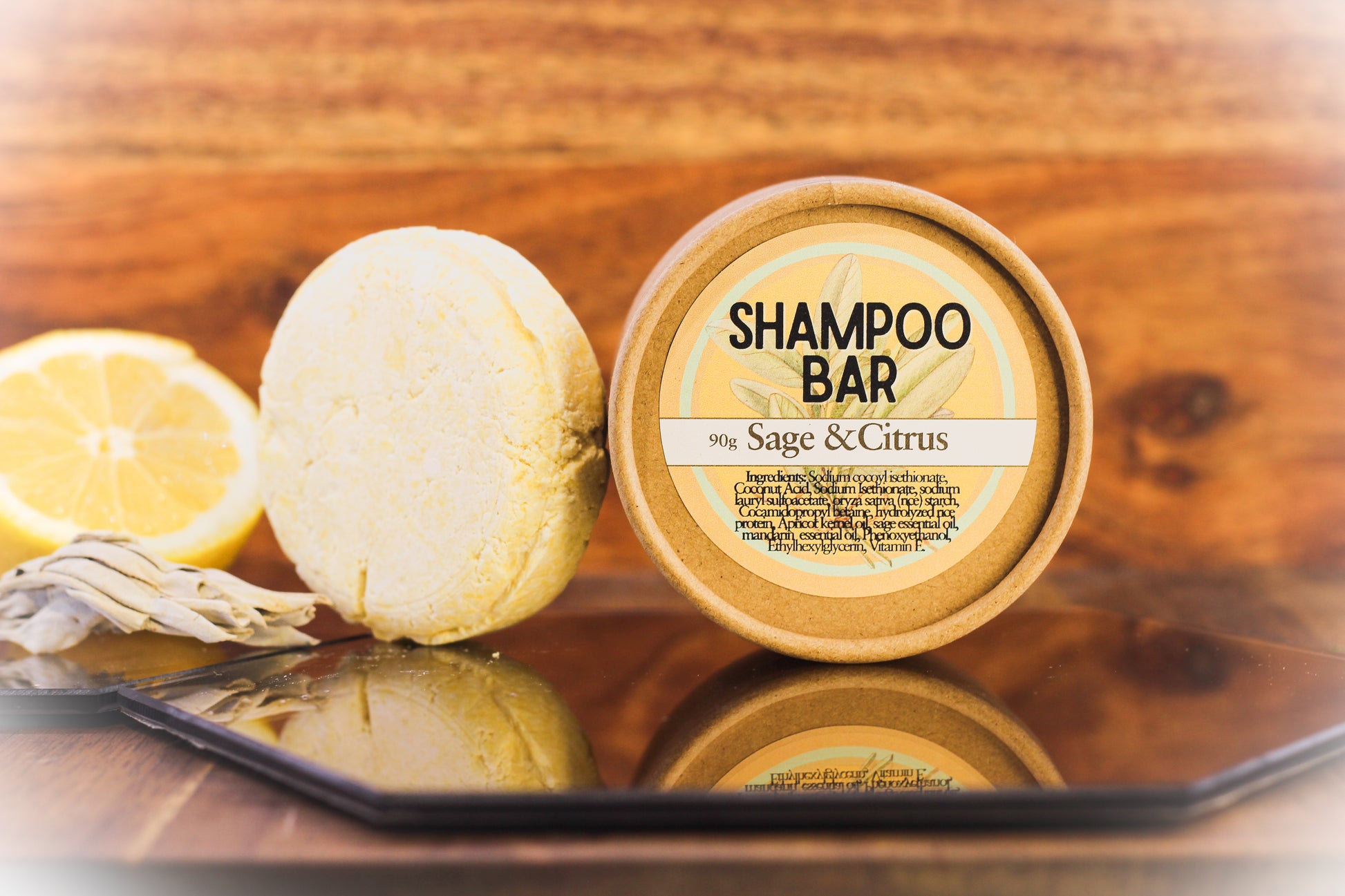 Shampoo bar and container on a wooden surface with lemons
